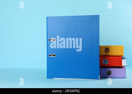 Hardcover office folders on light blue background Stock Photo