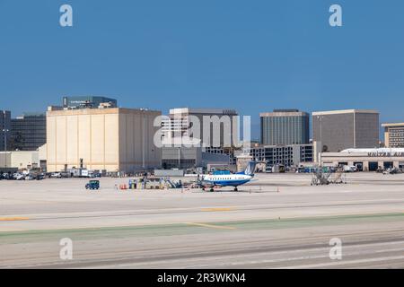 Los Angeles, USA - June 29, 2012:   cars and loaders ready to unload next aircraft, United Airlines aircrafts standing at the terminal gates ready for Stock Photo