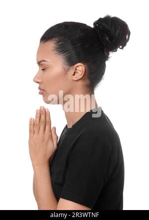 African American woman with clasped hands praying to God on white background Stock Photo