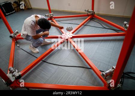 (230525) -- GUIYANG, May 25, 2023 (Xinhua) -- A staff member works on a model related to Five-hundred-meter Aperture Spherical Radio Telescope (FAST) at the State Key Laboratory of Public Big Data at Guizhou University in Guiyang, southwest China's Guizhou Province, May 23, 2023. As the first of its kind in the field of big data in the country, Guizhou University's State Key Laboratory of Public Big Data has three stable research directions, including multi-source data fusion and integration technology, public big data security and privacy protection, block data and regional governance. (Xinhu Stock Photo