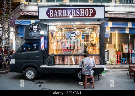 A mobile barber shop set up in Soi 1 Patpong Bangkok Thailand. Stock Photo