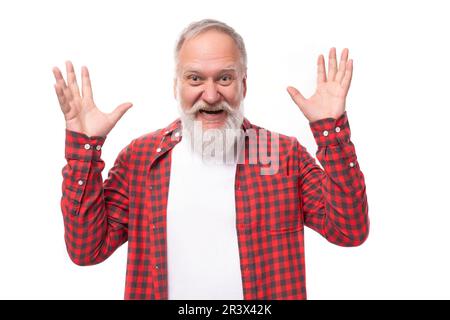 happy joyful 60 year old gray haired pensioner man with beard and mustache in casual look Stock Photo