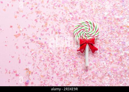 Colorful Sweet Lollipop For Children On pink Background with shiny glitter with copy space Stock Photo