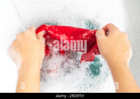 Handwash in loundry sink with white foam Stock Photo