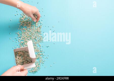 Woman Decorating backround with gypsophila flowers with copy space on light green background, flat lay Stock Photo