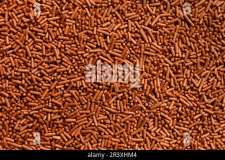 Chocolate chip background close-up, milk chocolate chip as abstract texture background with space for text. Stock Photo