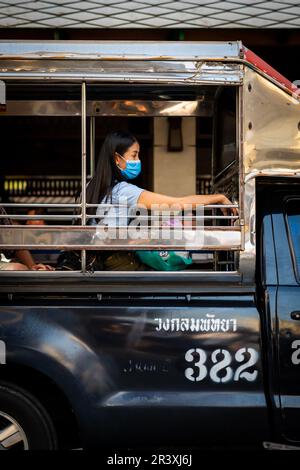 A passengers sat in the back of the baht bus as it makes its way ...