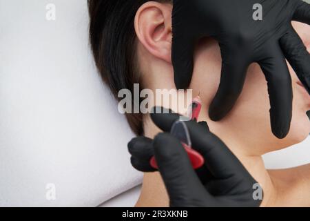 Beautiful woman gets an injection in her face Stock Photo