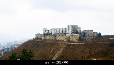 Krak (Crac) des Chevaliers, also called (Castle of the Kurds), and formerly Crac de l'Ospital, is a Crusader castle in Syria and one of the most impo Stock Photo