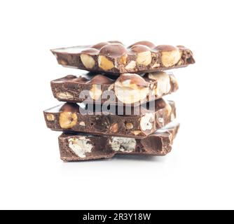 Broken chocolate bars with  nuts isolated on the white background. Stock Photo