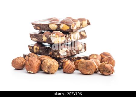 Broken chocolate bars with  nuts isolated on the white background. Stock Photo