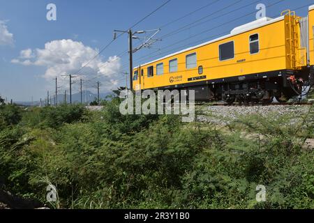 Bandung Regency, Tegalluar, West Java, Indonesia. May 25, 2023. A grinder train crosses the Jakarta-Bandung Fast Train Station in Tegalluar, Bandung Regency, Indonesia. Credit: Dimas Rachmatsyah/Alamy Live News Stock Photo