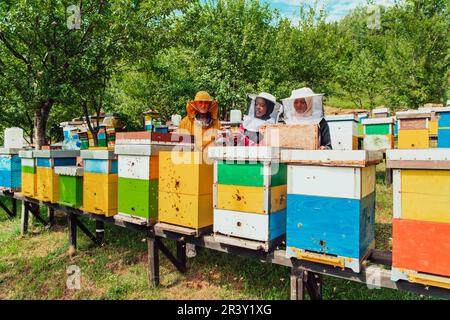 Arab investors checking the quality of honey on a large bee farm in which they have invested their money. The concept of investi Stock Photo