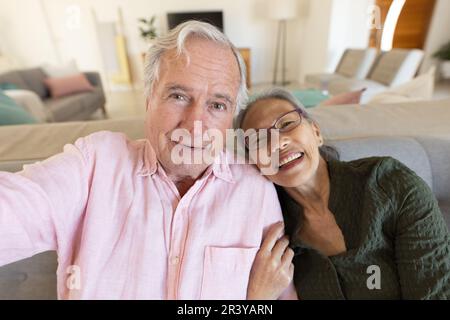 Happy senior diverse couple having video call Stock Photo