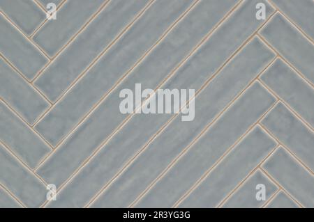 Long blue gray tile pattern with light glaze finish, diagonal pattern on a wall, background image. Color swatch design sample. Stock Photo