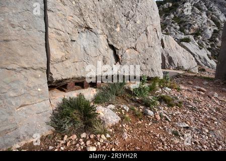 Abandoned Marble Quarry with Rusty Metal Wedges & Cut Marble Block or Rock with Wire Saw Marks on Montagne Sainte-Victoire Mountain Provence France Stock Photo