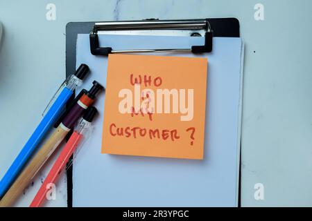 Concept of Who is My Customer? write on sticky notes isolated on Wooden Table. Stock Photo