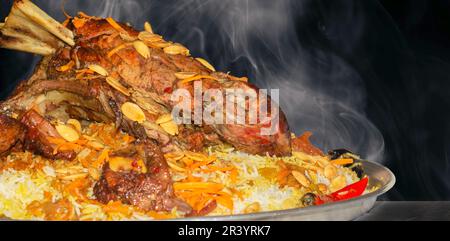 Mandi is a traditional dish from Yemen of meat, rice, and spices. It is now very popular in other areas of the Arabian Peninsula, and it is also commo Stock Photo