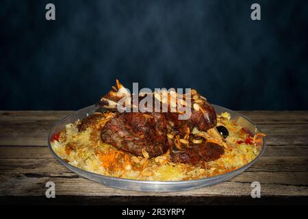 Mandi is a traditional dish from Yemen of meat, rice, and spices. It is now very popular in other areas of the Arabian Peninsula. Stock Photo