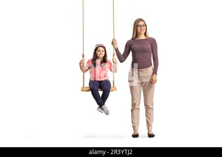 Mother standing next to girl on a wooden swing isolated on white background Stock Photo