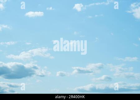 Sky. Blue sky with white clouds background. Curly clouds on a sunny summer day. Light cloudy. Good weather. Simple background sky for summer poster. S Stock Photo