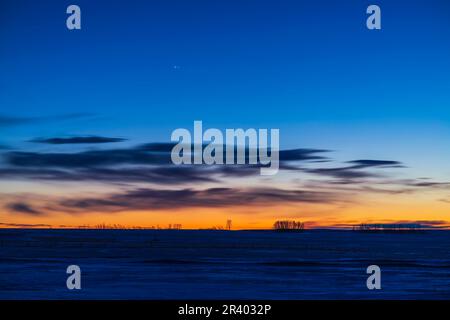 The pairing of Jupiter and Saturn in the evening twilight, southern Alberta, Canada. Stock Photo