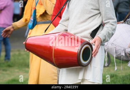 Drummer hands playing Mridanga or Satnam drum with light and cheerful clothes Stock Photo