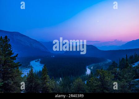Smoky waxing crescent moon over the Bow Valley in Banff, Alberta, Canada. Stock Photo