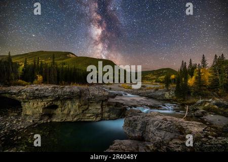 The summer Milky Way over the Elbow River and Elbow Falls in southern Alberta, Canada. Stock Photo