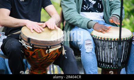 Drummer hands playing the ethnic djembe drum. Stock Photo