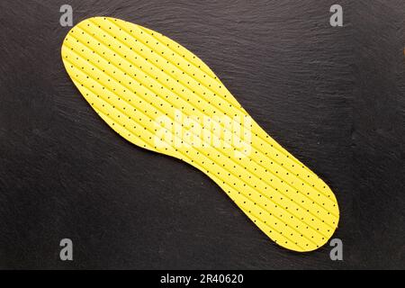 One latex insole on slate stone, top view. Stock Photo