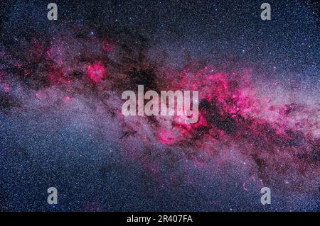 A framing of the major areas of bright and dark nebulosity in Cygnus and Cepheus, showing pink emission nebulas contrasting with dark dusty regions in Stock Photo