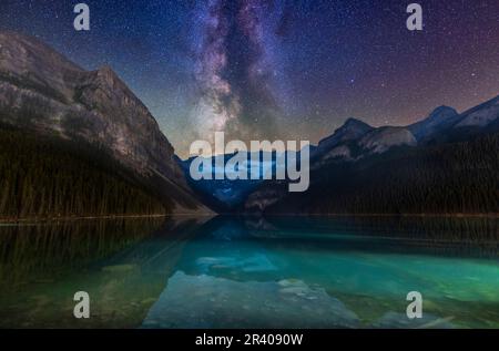The Milky Way over glacier-fed Lake Louise and Victoria Glacier in Banff National Park, Alberta, Canada. Stock Photo