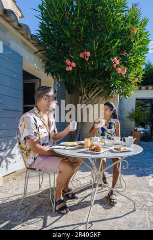 Couple having breakfast in a garden at a luxury vacation in the Provence France, Stock Photo