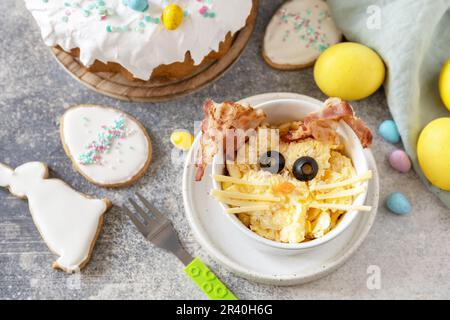 Easter breakfast idea. Scrambled eggs easter bunny on a stone background. Stock Photo