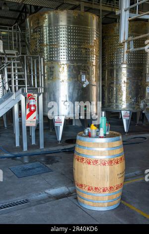 An oak wine barrel & stainless steel fermentation vats at the Ferrer Winery in Gualtallary, Tupungato, Valle de Uco,  Argentina. Stock Photo