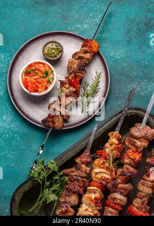 Bbq grilled meat pork and vegetable skewers on gray plate . Top view, flat lay Stock Photo