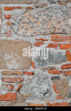 Vertical frame wall structure of an old house made of wild stone and brick, idea for a background or framing space, Stock Photo