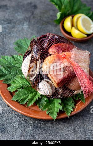 Famous traditional dish of the south of Chile and the Chiloe archipelago - Curanto al Hoyo, Kuranto.  Different seafood,  meat a Stock Photo