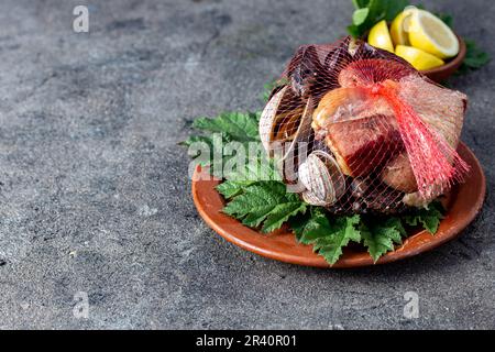 Famous traditional dish of the south of Chile and the Chiloe archipelago - Curanto al Hoyo, Kuranto.  Different seafood,  meat a Stock Photo