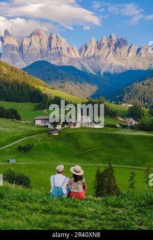 Couple viewing the landscape of Santa Maddalena Village Val di Funes, South Tyrol, Italy Dolomites Stock Photo