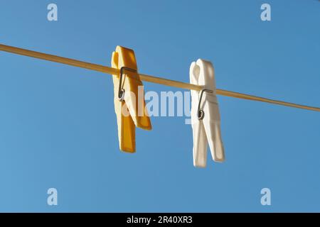 Clothespins on rope and blue sky Stock Photo