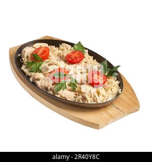 Traditional Italian lunch - pasta with chicken and mushrooms with cheese. Chicken and mushroom in cream sauce with homemade pasta, isolated on white. Stock Photo