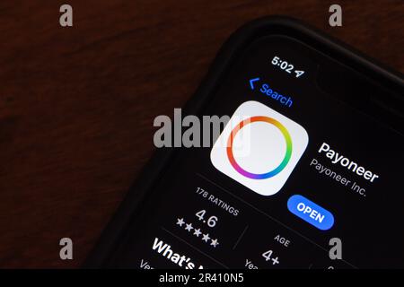 Payoneer app icon seen in an App Store on an iPhone screen. Payoneer is money transfer and payment platform that extends across the world Stock Photo