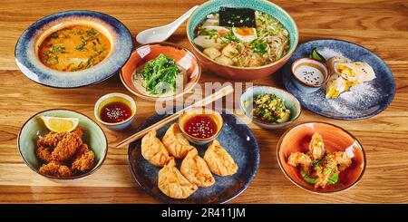 Set of assorted pan asian dishes. Chinese, Korean, Japanese cuisine. Soups, dumplings, noodles, rice and desserts. Stock Photo