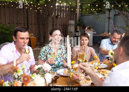 Many people saying cheers and showing their champagne glasses. Wedding party Stock Photo