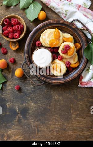 Healthy and delicious morning breakfast. Homemade cottage cheese pancakes gluten free (syrniki, curd fritters) with berries on w Stock Photo