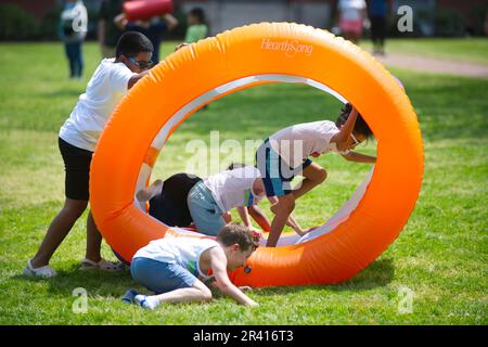 Open Streets - Hyannis, Massachusetts, USA. Children at play with inflatables Stock Photo