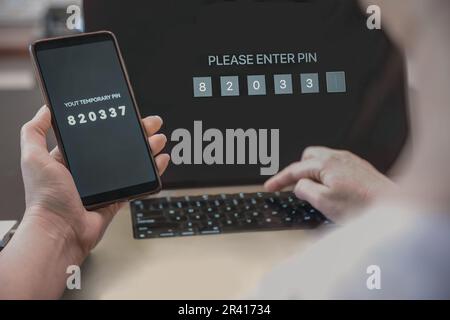 A woman enters a one-time password to verify, a secure mobile one-time password verification method, a two-step authentication web page. Stock Photo