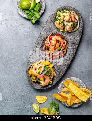 CEVICHE. Three colorful shrimps ceviche with mango, avocado and tomatoes. Latin American Mexican Peruvian Ecuadorian food. Serve Stock Photo